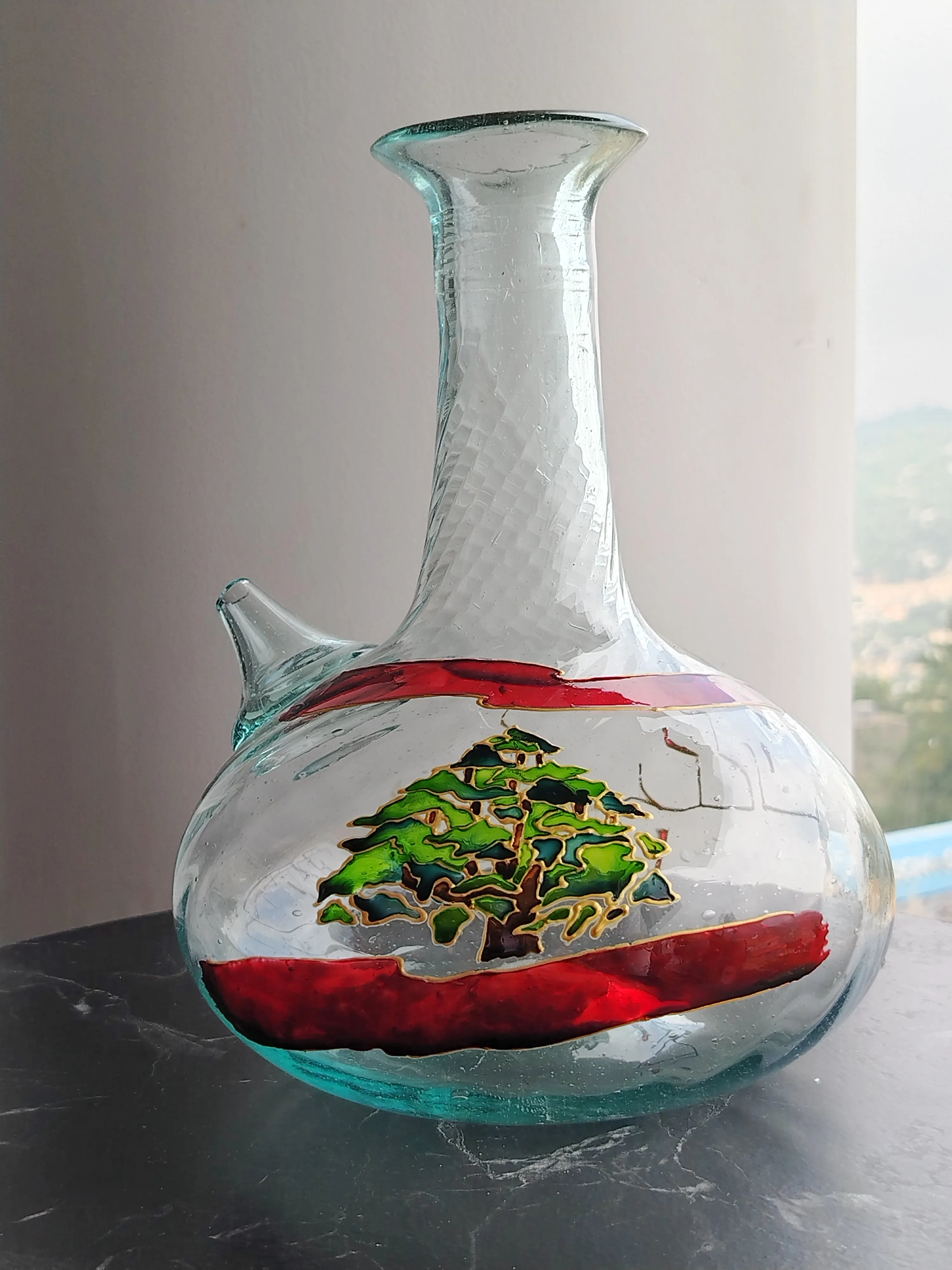 Hand-painted glass jug featuring the Lebanese cedar and flag, a living symbol of heritage