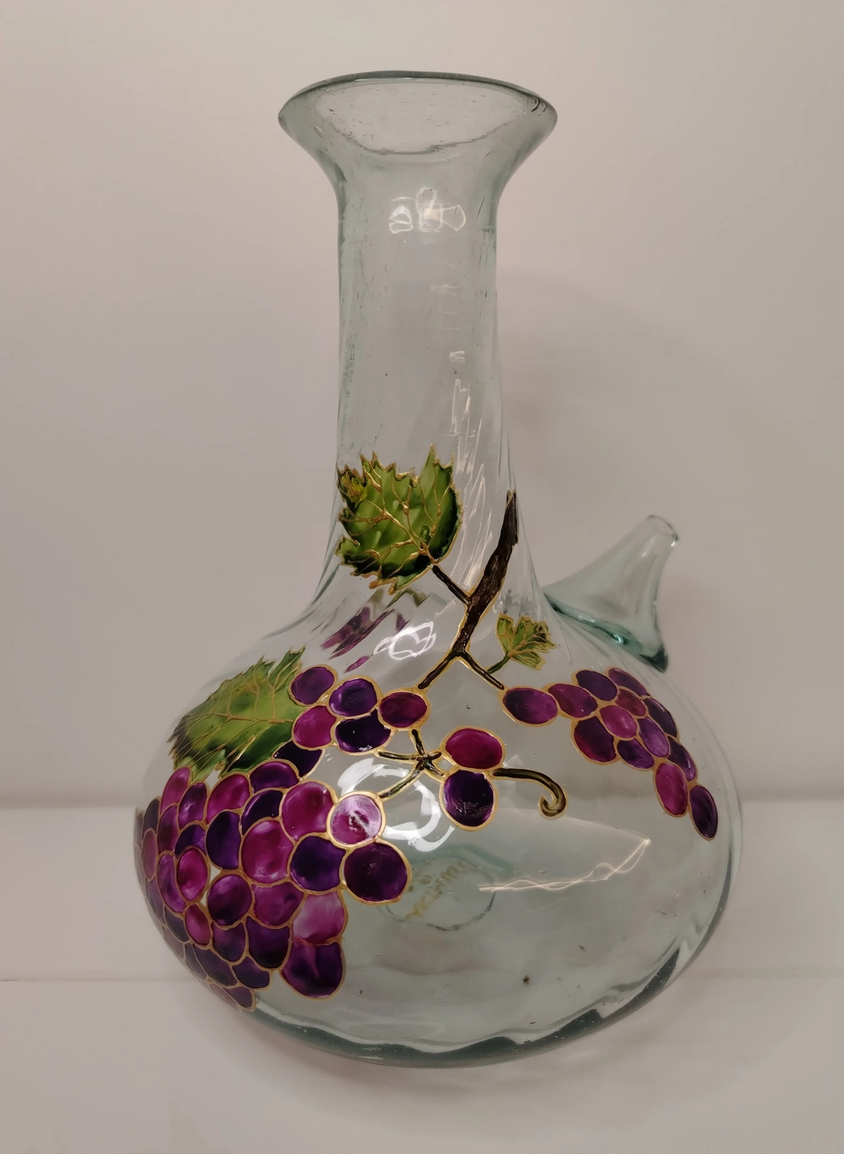 Hand-painted glass jug with deep purple grape clusters and gold vines on a clean white background